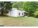 Large detached garage with white siding and a convenient side entrance, sits on a well-manicured lawn at 1112 Haver Ct, Mcdonough, GA 30252