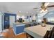 The kitchen and dining area features a breakfast bar, white cabinets, and a ceiling fan at 1112 Haver Ct, Mcdonough, GA 30252