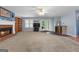 Large living room features a cozy brick fireplace and access to the backyard at 1112 Haver Ct, Mcdonough, GA 30252