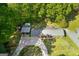 Aerial view of a home with a driveway, a carport and lots of surrounding trees at 118 Duvall Dr, Stockbridge, GA 30281