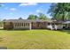 Spacious backyard featuring a well-maintained lawn, sunroom, and deck perfect for entertaining at 118 Duvall Dr, Stockbridge, GA 30281