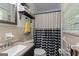 Well-lit bathroom with a vanity and a shower with a black and white curtain at 118 Duvall Dr, Stockbridge, GA 30281