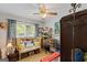 Bright bedroom featuring a desk area, a bench with pillows, and hardwood floors at 118 Duvall Dr, Stockbridge, GA 30281