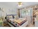 Bright bedroom featuring a cozy bed with pillows and shelves with decor at 118 Duvall Dr, Stockbridge, GA 30281