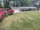 Charming brick ranch home with a well-manicured front yard and lovely, mature landscaping at 118 Duvall Dr, Stockbridge, GA 30281