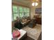 Inviting sunroom boasts tons of natural light, rustic decor, and cozy seating at 118 Duvall Dr, Stockbridge, GA 30281