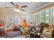 Bright sunroom with multiple windows and a ceiling fan providing ample natural light at 118 Duvall Dr, Stockbridge, GA 30281