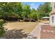 Landscaped backyard with a brick paver walkway leading to a covered patio at 21 Highbush Ct, Sharpsburg, GA 30277