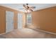 Cozy bedroom features two white doors and one window providing natural light plus a ceiling fan with lighting at 21 Highbush Ct, Sharpsburg, GA 30277