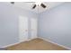 This secondary bedroom features ample room, and has a ceiling fan and two closets for storage at 21 Highbush Ct, Sharpsburg, GA 30277