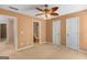 Spacious bedroom features neutral carpet, ceiling fan with lights, and convenient access to the bathroom and closets at 21 Highbush Ct, Sharpsburg, GA 30277