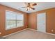 Bedroom with carpet flooring, ceiling fan, and large window at 21 Highbush Ct, Sharpsburg, GA 30277