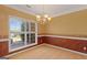 Dining room featuring large window providing natural light and a decorative chandelier at 21 Highbush Ct, Sharpsburg, GA 30277
