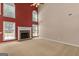 Spacious living room featuring a cozy fireplace, large windows, and neutral carpet at 21 Highbush Ct, Sharpsburg, GA 30277