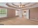 Bright primary bedroom with two windows and double doors leading to the primary bathroom with a soaking tub at 21 Highbush Ct, Sharpsburg, GA 30277