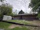 Backyard featuring mature trees, grass, shed, brick, patio and stairs at 7336 Howard Cir, Jonesboro, GA 30236