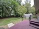 The backyard features a patio, stairs, grass, mature trees, and a shed at 7336 Howard Cir, Jonesboro, GA 30236
