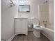 Bathroom featuring a toilet, bathtub, vanity, mirror, and modern floors at 7336 Howard Cir, Jonesboro, GA 30236