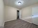 A bedroom with neutral walls, modern floors, and a white door at 7336 Howard Cir, Jonesboro, GA 30236