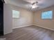 This bedroom features neutral walls, modern floors, and a ceiling fan with attached light at 7336 Howard Cir, Jonesboro, GA 30236