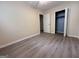 This bedroom has neutral walls, modern floors, an open closet, and a white door at 7336 Howard Cir, Jonesboro, GA 30236