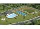 Aerial view of community amenities including a swimming pool, clubhouse, tennis courts, and playground at 737 Myrica Ave, Locust Grove, GA 30248