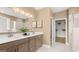 Elegant bathroom with double vanity, wood cabinets, and a walk-in shower and closet at 737 Myrica Ave, Locust Grove, GA 30248