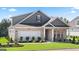 Beautiful two-story home with brick accents, well-manicured lawn, and a welcoming covered entrance at 737 Myrica Ave, Locust Grove, GA 30248