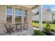 Charming covered front porch with chairs perfect for enjoying the outdoors at 737 Myrica Ave, Locust Grove, GA 30248