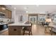 Open-concept kitchen flowing into the dining area, featuring a large island and modern appliances at 737 Myrica Ave, Locust Grove, GA 30248