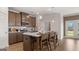 Modern kitchen featuring stainless steel appliances, a central island with bar seating, and pendant lighting at 737 Myrica Ave, Locust Grove, GA 30248
