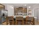 Modern kitchen with stainless steel appliances, wooden cabinets, and a center island with bar stool seating at 737 Myrica Ave, Locust Grove, GA 30248