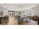 Open-concept living room with contemporary furnishings, large windows, and seamless flow to dining area at 737 Myrica Ave, Locust Grove, GA 30248