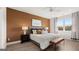 Well-lit main bedroom with wood floors, stylish furnishings, and a large window overlooking the greenery at 737 Myrica Ave, Locust Grove, GA 30248