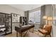 A home office featuring a large window, modern desk, and built-in shelving for optimal organization at 737 Myrica Ave, Locust Grove, GA 30248