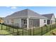 Exterior view of a home with a screened porch, fenced yard, and well-maintained landscaping at 737 Myrica Ave, Locust Grove, GA 30248