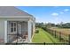 Exterior view of a screened porch with a ceiling fan and backyard access at 737 Myrica Ave, Locust Grove, GA 30248