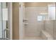Modern walk-in shower with glass enclosure, tiled walls, and a built-in bench at 737 Myrica Ave, Locust Grove, GA 30248