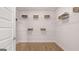 A well-organized walk-in closet with white wire shelving and wood-look flooring at 737 Myrica Ave, Locust Grove, GA 30248