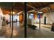 Large unfinished basement with exposed support beams, flooring, and work-out area at 215 Ridge Rd, Tyrone, GA 30290