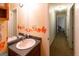 Half bathroom with decorated mirror and view into hallway at 215 Ridge Rd, Tyrone, GA 30290