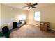 Spacious bedroom with a ceiling fan, window, and ample room for storage or decor at 215 Ridge Rd, Tyrone, GA 30290