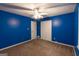 Blue bedroom with ceiling fan and closet at 215 Ridge Rd, Tyrone, GA 30290