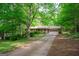 Charming single-story home with brick accents, lush greenery, and a driveway leading to an attached garage at 215 Ridge Rd, Tyrone, GA 30290