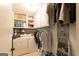 Well-organized laundry room with washer, dryer, shelving, and clothing racks at 215 Ridge Rd, Tyrone, GA 30290