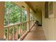 View of the covered front porch with a wooden railing, providing a cozy entrance to the home at 215 Ridge Rd, Tyrone, GA 30290
