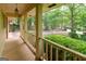 Inviting covered porch with wooden railings, offering a view of the tree-lined street and front yard at 215 Ridge Rd, Tyrone, GA 30290