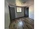 View of an empty bedroom with hardwood floors, closet and lots of light at 2016 Conrad Se Ave, Atlanta, GA 30315