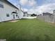 Large, grassy backyard enclosed by white and wooden fences offering privacy and space at 1130 Ivey Ln, Mcdonough, GA 30253