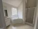 Bright bathroom with a shower, bathtub, vanity, and window at 1130 Ivey Ln, Mcdonough, GA 30253